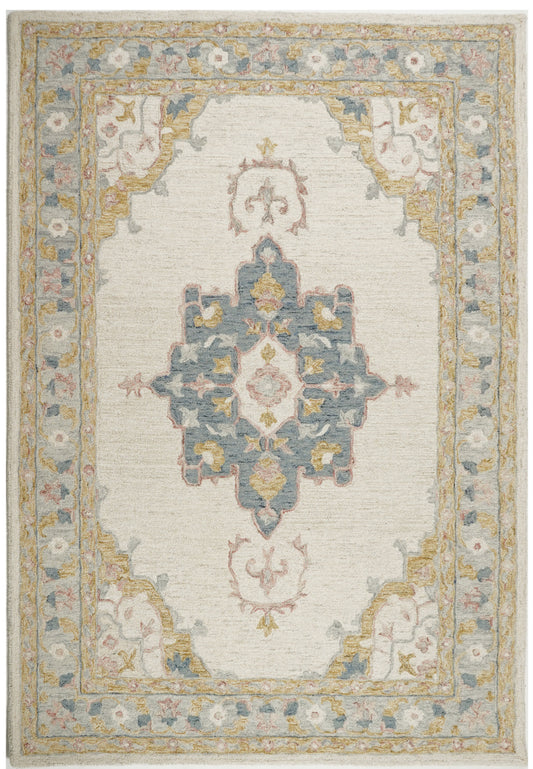 Śīlābhā cream wool rug with a blue floral medallion, ochre-edged corner panels and a blue-grey border.