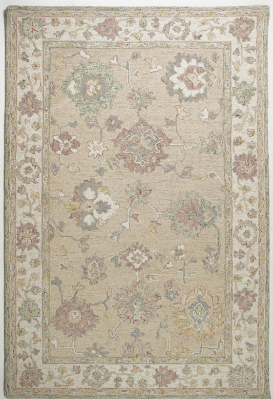 Palāśavarṇa beige wool rug with dusty pink and sage floral motifs and a broad cream botanical border.