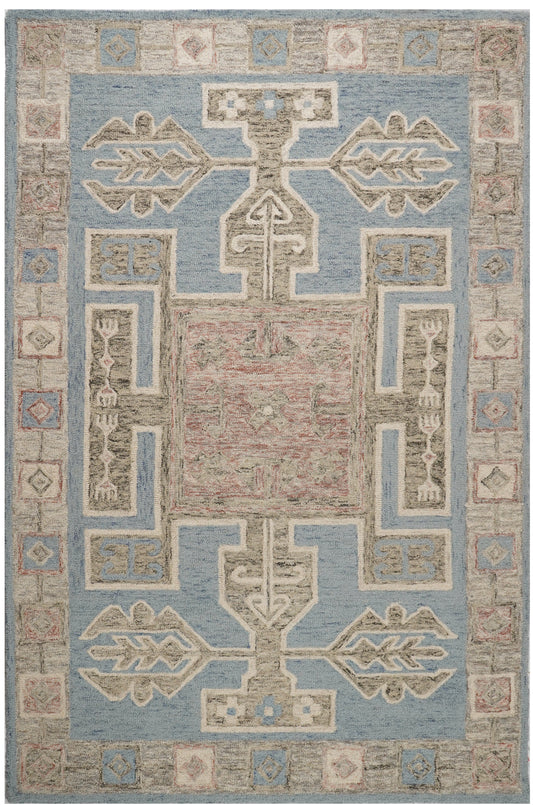 Mayan blue wool rug with a dusty pink central panel, cream geometric motifs and a patterned block border.